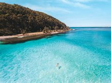 Woman swimming in the water at North Durras, Murramarang National Park 