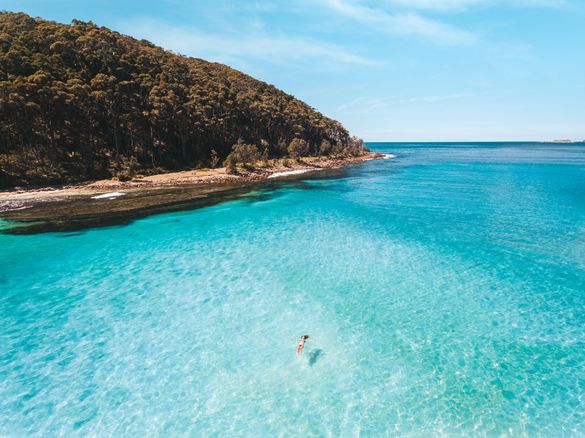 Woman swimming in the water at North Durras, Murramarang National Park 