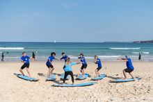 Small group enjoying a learning to surf experience with Lets Go Surfing, Bondi Beach