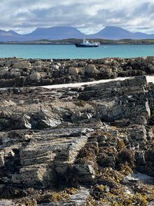 The Hjalmar Bjørge anchored off Oronsay with the Paps of Jura as a backdrop