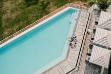 Couple relaxing by the pool at Bannisters, Port Stephens