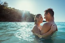 Couple enjoying the turquoise waves at a beach in Ocho Rios. 