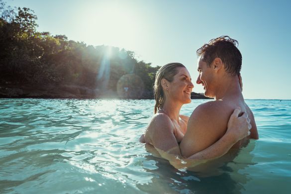 Couple enjoying the turquoise waves at a beach in Ocho Rios. 