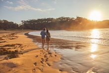 Couple enjoying a visit to McKenzies Beach, Malua Bay