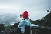 Woman capturing a photo from Dorrigo Skywalk Lookout, Dorrigo National Park