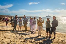 Coral Expeditions guests enjoying sunset drinks on Reevesby Island.