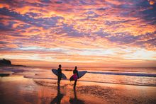 Surfers enjoying a morning in the water off Nobbys Beach, Newcastle.