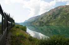 White Pass train travelling along Lake Bennett