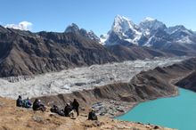 Trekking group taking a rest after walking to the summit of Gokyo Ri
