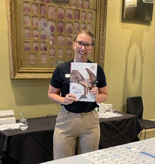 Sales Executive Gaby Percy holding new Expedition Atlas at Roadshow event