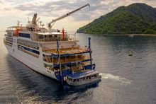 Coral Adventurer - Lowering Xplorer with guests into the water using the hydrolic lift at the back of the ship.