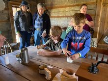 Children make their butter at Historic Collinsville Pioneer Settlement.