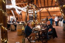 (Foreground) Ann Nemanic, executive director of GO Laurel Highlands, talks with Matt  Falenski, owner of Laurel Highlands Meadery in Greensburg, during an event at SanaView Farms and Winery, Champion.