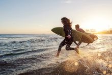 Surfers hit the waves