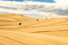 Group enjoying a quad bike tour on the Stockton Sand Dunes with Sand Dune Adventures