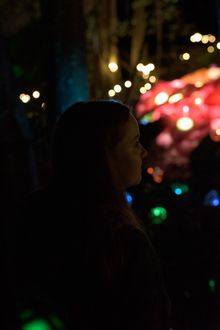 Girl watching flowers installation at Nocturnal 