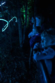 Kids along boardwalk watching lights