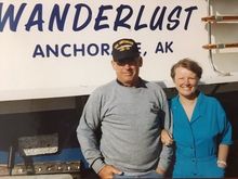 Jim & Jan Thurston with the boat they first lived on in Halibut Cove