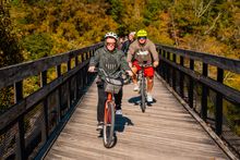 Cyclists on the Great Allegheny Passage in Ohiopyle, a charming borough in the Laurel Highlands of Southwestern Pennsylvania.