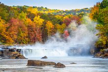 Mist rises above Ohiopyle Falls on a crisp autumn day in Pennsylvania's Laurel Highlands.