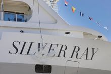 The ceremonial champagne bottle break on Silver Ray's hull