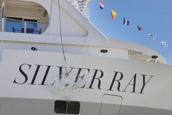 The ceremonial champagne bottle break on Silver Ray's hull