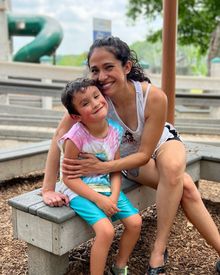 A mom and son enjoy time at Liberty Park's community built playground..