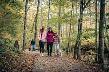 A family enjoys fall color on a trail at Clarksville's Rotary Park.