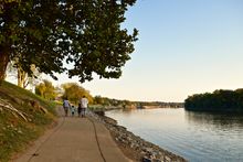 A family enjoys an evening stroll on the Cumberland Riverwalk.