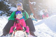 Tobogganing with the kids is a great family activity. 