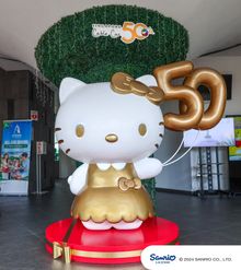 Hello Kitty sculpture dressed in a gold ensemble