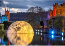 Spectacle of Light Christmas Light Trail at Sudeley Castle. Photo shows moon installation in the castle's moat