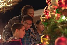 A family is in awe of the City of Clarksville Christmas Tree on Public Square.