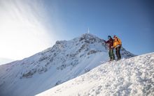 A couple skiing in St. Johann in Tirol. 