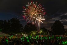 Fireworks light up the night sky over the Laurel Highlands as children play with glow sticks. 