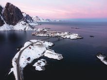 Aerial view of snow-covered cliffs and icebergs in a polar landscape in the Lofoten Islands.