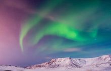 Image of a vibrant aurora borealis in the night sky in Iceland