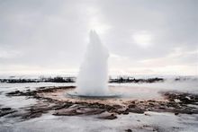 A powerful geyser erupting into the sky in Iceland