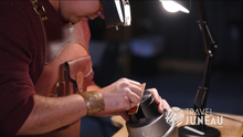 Multi-disciplinary artist, Lee, works carving formline designs on a copper bracelet.