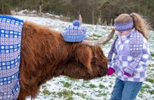 COME COO-RIE IN: Julie the Highland 'super moo-del' cow, from Newton Farm Holidays & Tours, is set to inspire visitors to wrap up warm and explore Scotland in winter, wearing a bespoke garment with a Scottish design created by knitters from the A’ The Air