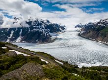 Couple viewing the Salmon Glacier near Stewart with RV in British Columbia