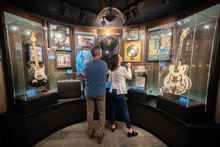 A couple looking at a display of electric guitars at Blues Hall of Fame in Memphis. 