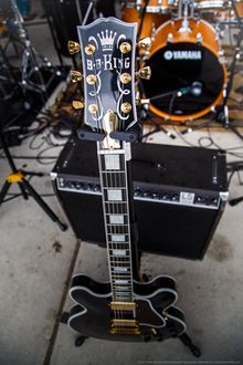 Electric guitar with a black finish and gold hardware bearing name of B.B. King. 