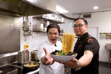 Jonathan Poh (left) and Junda Khoo with their Flying Noodles dish in the kitchen at Scenic World 