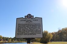 An Affricanna Town historic marker stands in Dunbar Cave State Park, telling the story of the site's refugee camp.