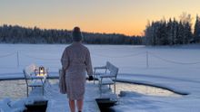 A woman approaching the 'avanto' (a hole in the ice) in order to go for a swim