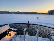 A woman swimming in the 'avanto' (a hole in the ice) 