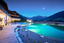 Der Böglerhof: A modern luxury outdoor infinity pool at dusk.