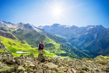 Two women standing in an alpine landscape. 