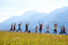A group doing yoga poses at the Mountain Yoga Festival in St. Anton.